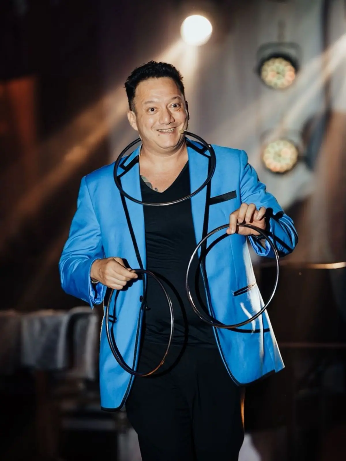 Jose Almenares performing stage magic at a corporate event